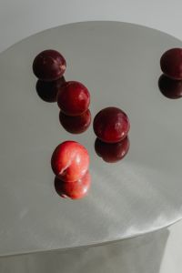 Kaboompics - Red Plums Reflected on Chrome Tabletop