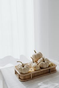 Kaboompics - White Pumpkins in a Wicker Tray on a White Table
