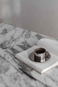 Kaboompics - Chrome Coffee Cup on Notebook and Arabescato Marble