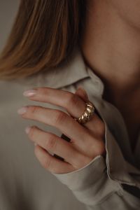 Kaboompics - Woman Touching Tan Silk Shirt Collar Wearing Gold Ring