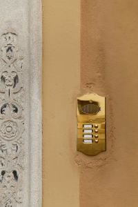 Kaboompics - Gold Brass Doorbell Panel Next to Ornate Stone Column, Italy