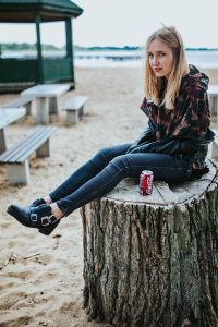 Kaboompics - Woman Resting on Beach Stump Near Pavilion and Picnic Benches