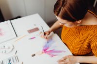 Kaboompics - A woman paints with watercolors