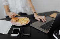 Kaboompics - Working Lunch With Burger Beside Laptop and Notebook
