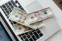 Kaboompics - US Dollar Bills on Laptop Touchpad