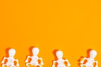 Kaboompics - Row of Mini Skeletons on Orange Background