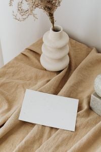 Kaboompics - Dried Branches in a Sculptural White Vase with Blank Card and Stone Decor