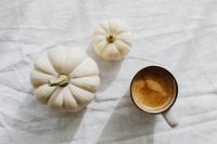 Kaboompics - Coffee Cup with White Mini Pumpkins on White Linen