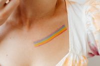 Kaboompics - Rainbow Body Paint Stripe Across a Woman's Chest, Close-Up