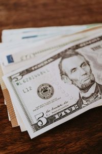 Kaboompics - Close-Up of US Five-Dollar Bill on Wooden Table, American Currency Detail