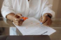 Kaboompics - Black Woman Highlighting a Printed Document