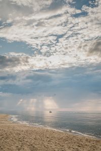 Kaboompics - Sun Rays and Distant Boat Over the Sea