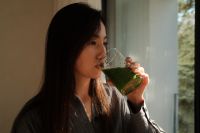 Kaboompics - Woman Enjoying a Green Smoothie by the Window