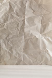 Kaboompics - Wrinkled Beige Paper Wall and White Surface