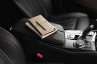 Kaboompics - Beige Journals and Pen on a Luxury Car Armrest