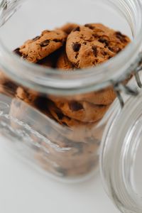 Kaboompics - Low-Angle View Through a Glass Jar Filled with Chocolate Chip Cookies