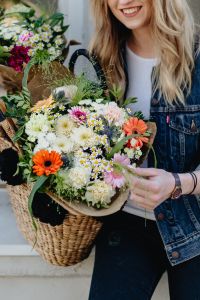 Kaboompics - Smiling Blonde Woman with Colorful Flower Basket
