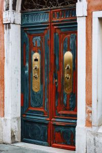 Kaboompics - Blue and Red Carved Wooden Door with Brass Handles in Venice