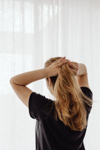 Kaboompics - Woman Gathering Hair to Make a Ponytail
