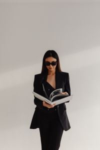 Kaboompics - Woman in a Black Suit and Sunglasses Reading a Magazine