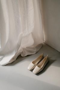 Kaboompics - White Pointed Slingback Pumps by Linen Curtain