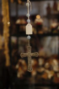 Kaboompics - Close-Up of Gold-Tone Cross Necklace with White Beads