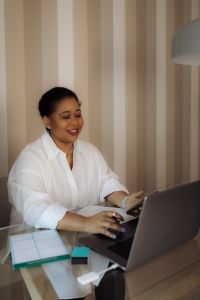 Kaboompics - Smiling Black Woman Working on Laptop