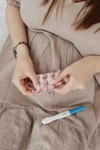 Kaboompics - Pregnant Woman Holding Pills and Pregnancy Test