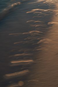 Kaboompics - Dark Sea Water Texture Golden Light Ripple Pattern