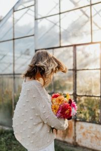 Kaboompics - Woman Spinning With Dahlia Bouquet In Greenhouse