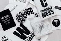 Kaboompics - Top View of Black and White Typography Cards and Abstract Scribble