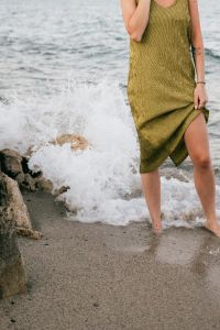 Woman on a Phone Call by the Sea in Sardinia, Italy: Coastal Summer Lifestyle Photography