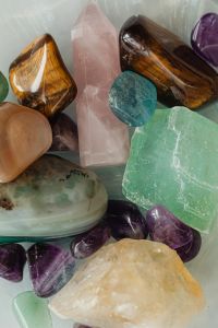 Kaboompics - Polished Tiger’s Eye and Rose Quartz Crystal Point with Colorful Gemstones