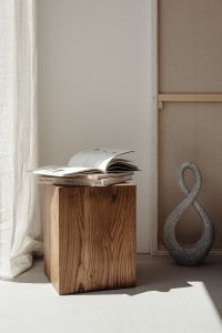 Kaboompics - Open Book on Walnut Side Table beside Loop Sculpture