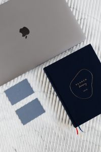 Kaboompics - Business Card Mockup with MacBook and Navy Planner on White Marble