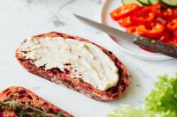 Kaboompics - Hummus Toast Close-Up with Sliced Pepper and Cucumber on Marble