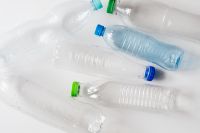Kaboompics - Clear Bottles with Blue and Green Caps Arranged at Angles