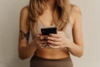 Kaboompics - Woman Holding a Smartphone While Seated in Yoga Clothes
