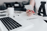 Kaboompics - Businesswoman uses her iPhone mobile at her desk