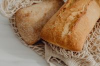 Kaboompics - Ciabatta and Baguette Nestled in a Cotton Mesh Bag