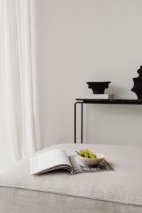 Kaboompics - Minimal Living Room Reading Scene with Sheer Curtains and Grapes