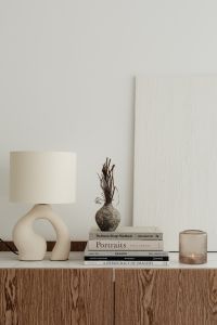 Kaboompics - Minimalist Sideboard Decor with Sculptural Ceramic Lamp and Candle, Portrait Layout