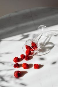 Kaboompics - Raspberries Spilling From Cut Crystal Glass