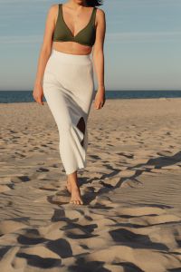 Kaboompics - Summer Beach Outfit with a White Slit Skirt and Green Top