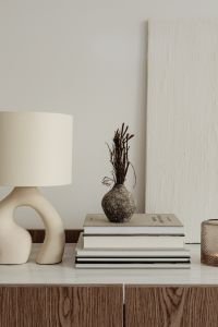 Kaboompics - Warm Neutral Home Decor Still Life with Ceramic Lamp, Books and Dried Botanicals