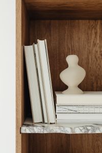 Kaboompics - Neutral Bookshelf Styling with a White Sculptural Vase