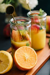 Kaboompics - Glass Jar Orange-Peach Drinks with Fresh Mint, Summer Refreshment Editorial Photo