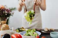 Kaboompics - Fresh Salad Being Served with Wooden Servers and Side Dishes