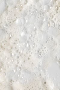 Kaboompics - Soft-Focus White Cleanser Foam with Fine Bubbles, High-Key Skincare Background