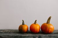 Kaboompics - Three Mini Pumpkins on Rustic Wooden Table